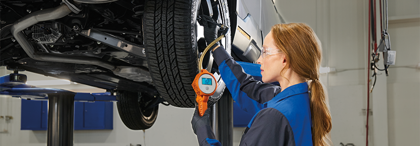 A Subaru technician checking tire pressure. | Bergstrom Subaru Green Bay in Green Bay WI