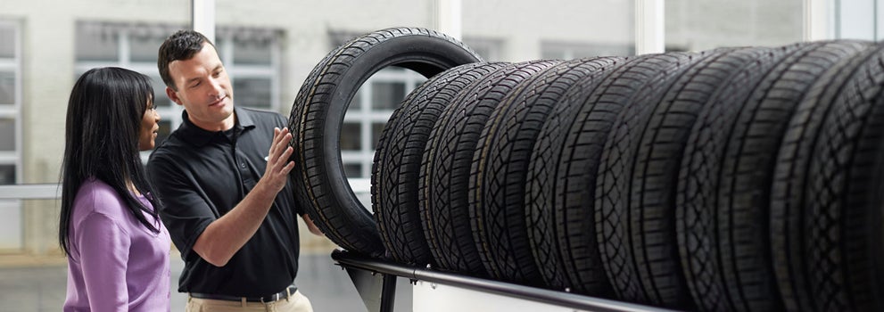 Subaru service representative showing customer a tire. | Bergstrom Subaru Green Bay in Green Bay WI