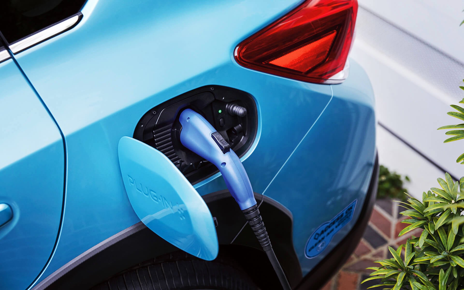 A close-up of the Subaru Crosstrek Hybrid's charging port with charging cable plugged in | Bergstrom Subaru Green Bay in Green Bay WI