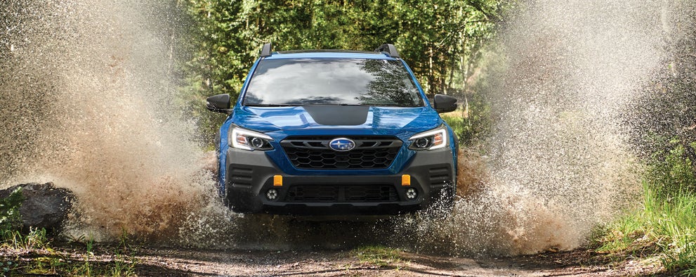 A 2023 Outback Wilderness driving on a muddy trail. | Bergstrom Subaru Green Bay in Green Bay WI