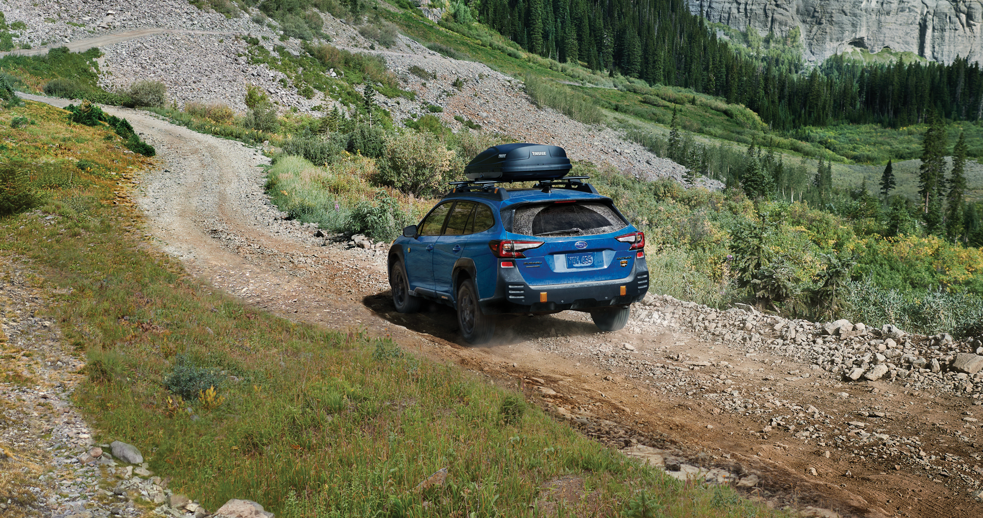A 2023 Outback Wilderness driving on a trail in the mountains. | Bergstrom Subaru Green Bay in Green Bay WI